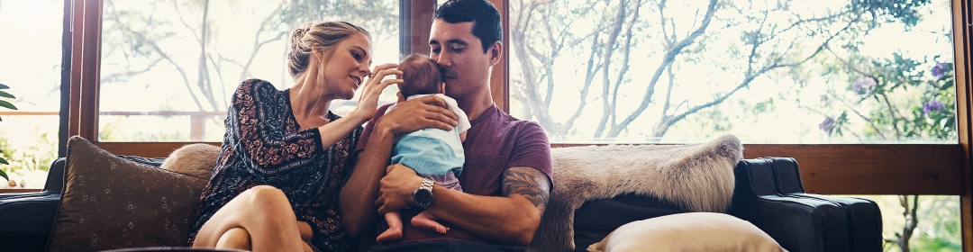 Woman and man holding baby