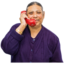 A customer talking on a red telephone