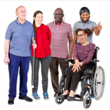 A group of people standing together smiling and looking happy