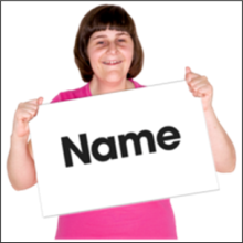 A person holding a piece of paper with the word 'name' written on it